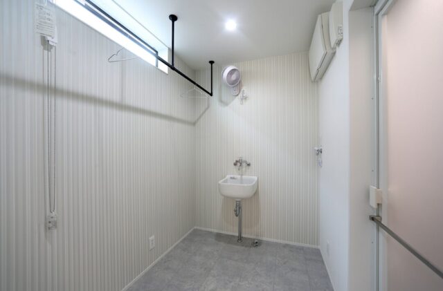 ホワイトとダークウッドのコントラストが魅せる和洋折衷の吹き抜けがある住まい - 空感考房CO.CO - 脱衣・ランドリールーム